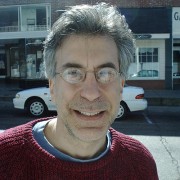 Smiling man with glasses and graying hair